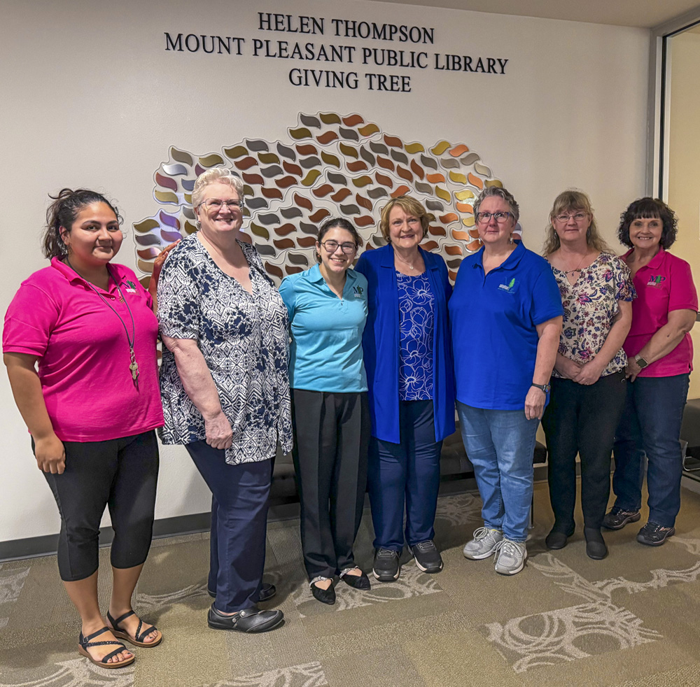 The Mount Pleasant Library Team who will carry on the Giving Tree include from left: Reyna Soto; Kim Pearson; Lupe Herrerra; with Helen; Jeanette McCoy; Natalie Fox; and Lavonne Hearron.